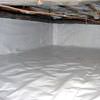 A crawl space vapor barrier has been installed on the walls and floors of this space in Eastpoint.