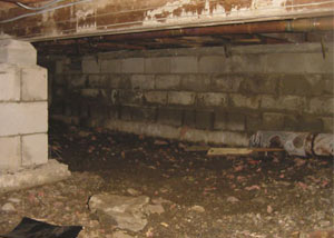 Rotting, decaying crawl space wood damaged over time in 